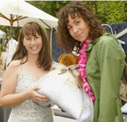 Actress Minnie Driver holding a babyinabag baby sleep sack